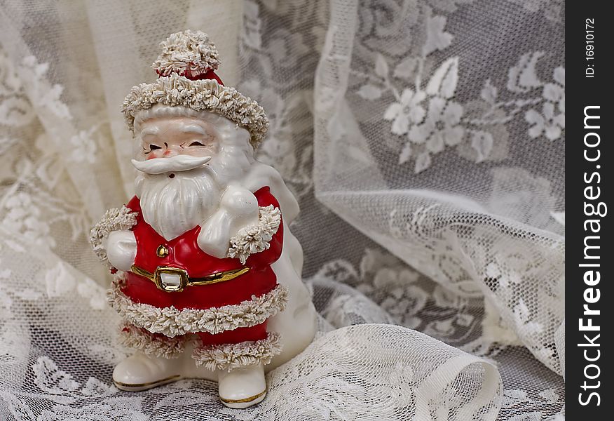 Vintage Porcelain Santa Claus on beige lace. Vintage Porcelain Santa Claus on beige lace
