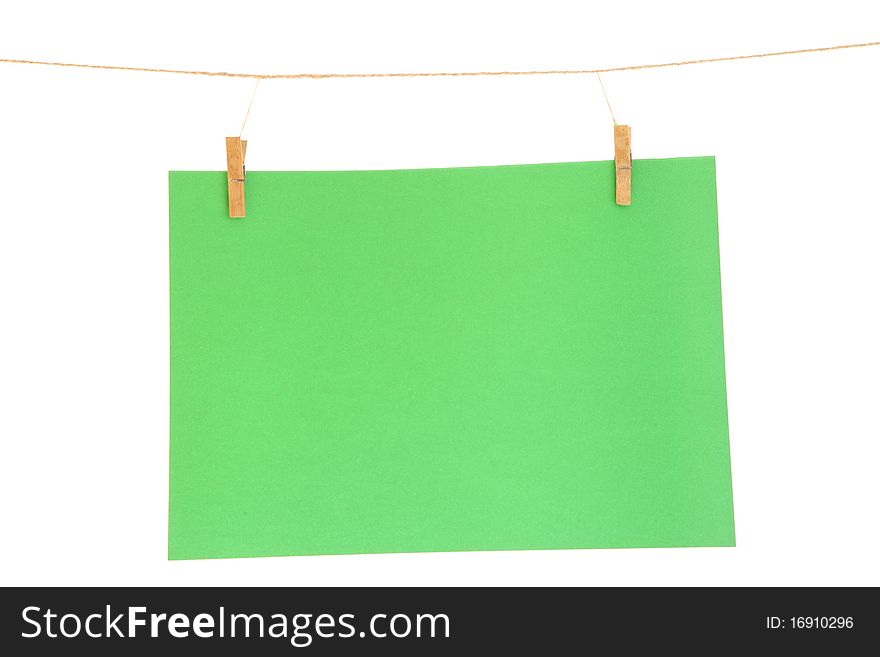 Green blank paper sheet on a clothes line. Isolated on white background. Green blank paper sheet on a clothes line. Isolated on white background.