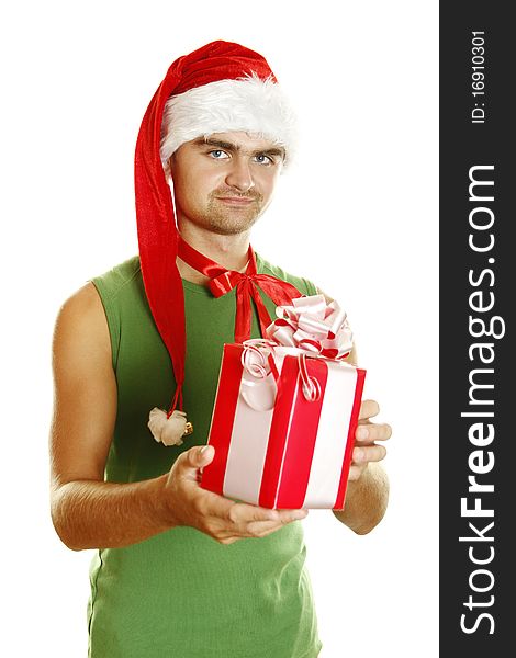 Young man in a Santa Claus hat and green poppy stretched to frame the big red Christmas box. Young man in a Santa Claus hat and green poppy stretched to frame the big red Christmas box