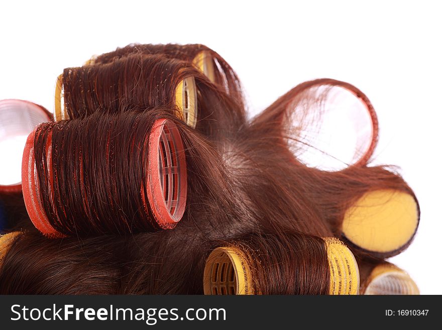 Close-up of curlers in hair isolated on white