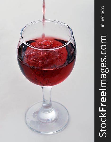 Red wine pouring into a wine glass