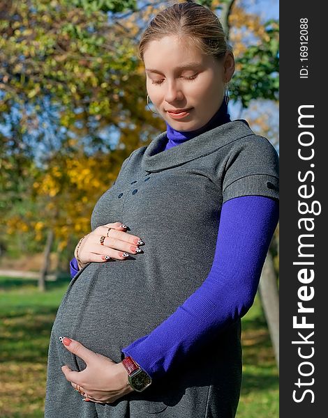 Beautiful pregnant woman in the park. Beautiful pregnant woman in the park