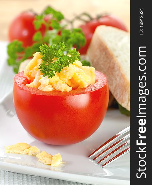 Fresh tomato with scrambled eggs and parsley. Fresh tomato with scrambled eggs and parsley