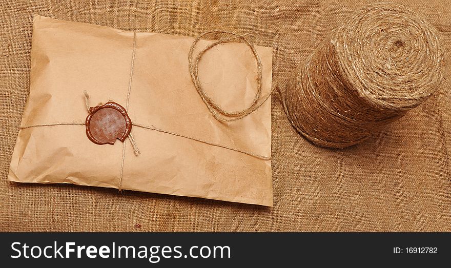 String hank and parcel on sack background