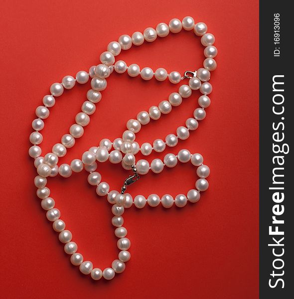 White pearls on the red background