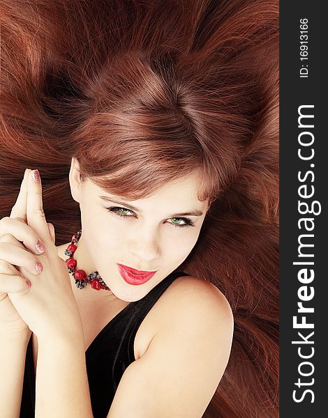 Red-haired coquettish young woman lies on the hair. Red-haired coquettish young woman lies on the hair