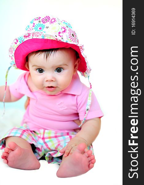 Baby girl with hat sitting. Baby girl with hat sitting