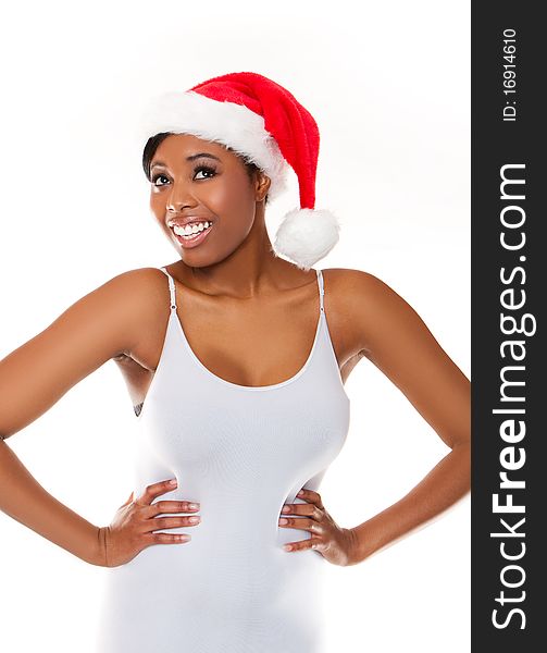 An isolated shot of a black woman celebrating christmas wearing santa hat