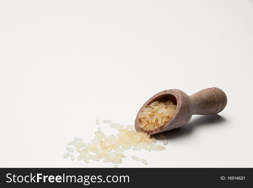 A closeup of white rice and a wooden spoon. A closeup of white rice and a wooden spoon