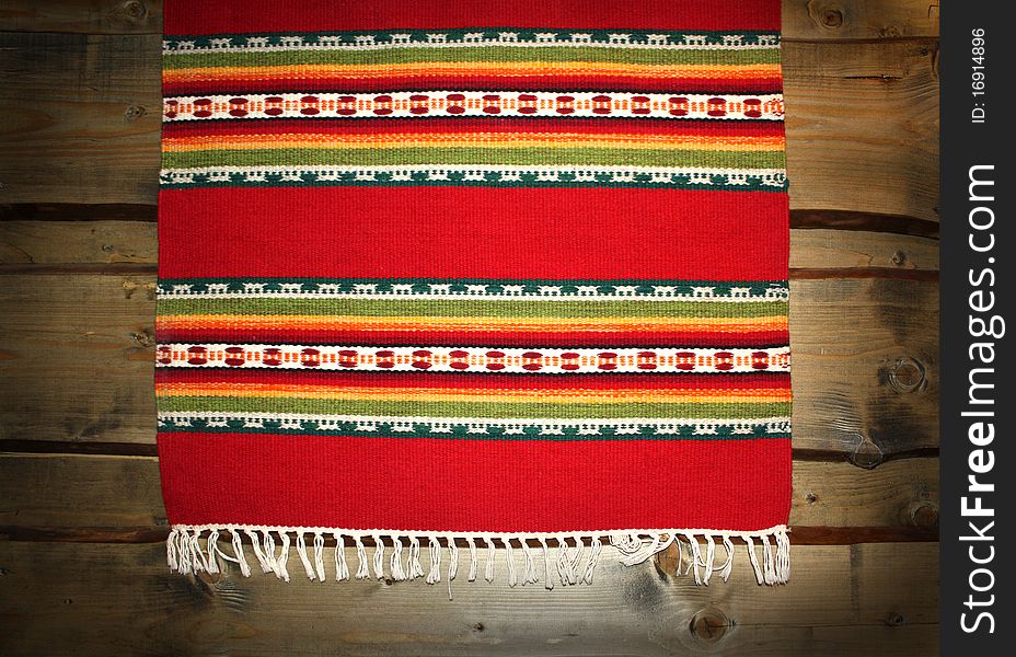 The textile traditional mat on wood backdrop