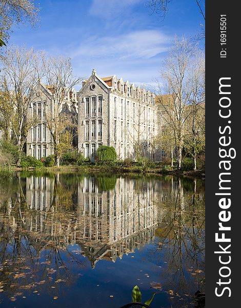 The old military headquarters and high school college building reflected over the lake at Parque D. Carlos I, in Caldas da Rainha, Silver Coast, Portugal. The old military headquarters and high school college building reflected over the lake at Parque D. Carlos I, in Caldas da Rainha, Silver Coast, Portugal