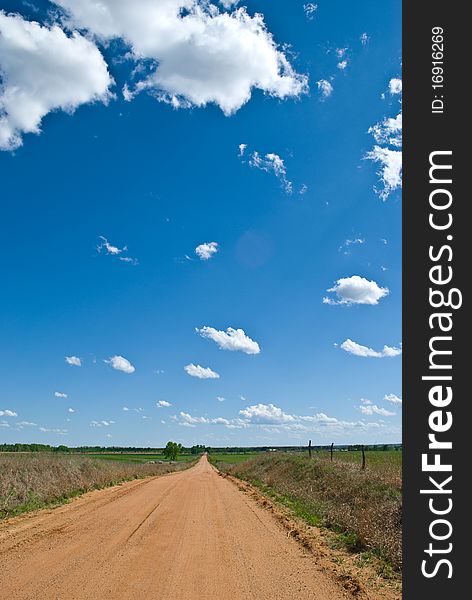 An old dirt road in the heartland on a beautiful day. An old dirt road in the heartland on a beautiful day