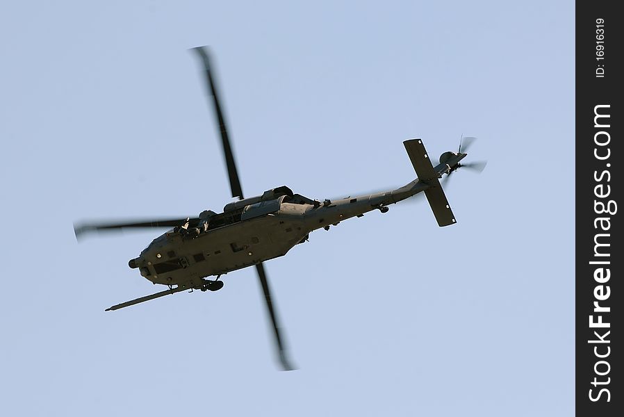 Modern military helicopter on a mission flying overhead