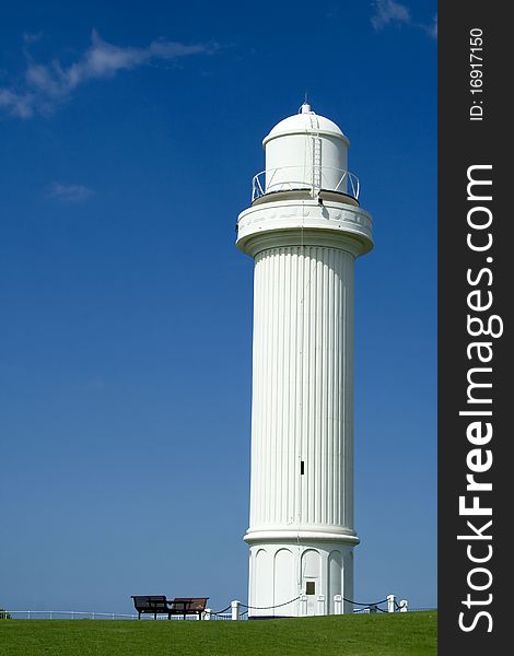 White light house under the clear blue sky. White light house under the clear blue sky