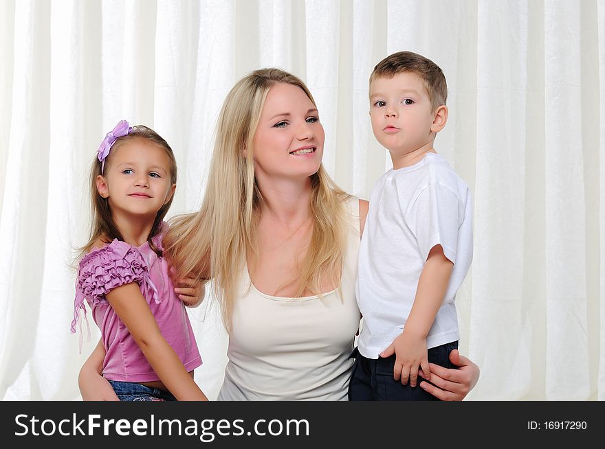 A young mother, her daughter and son having fun together