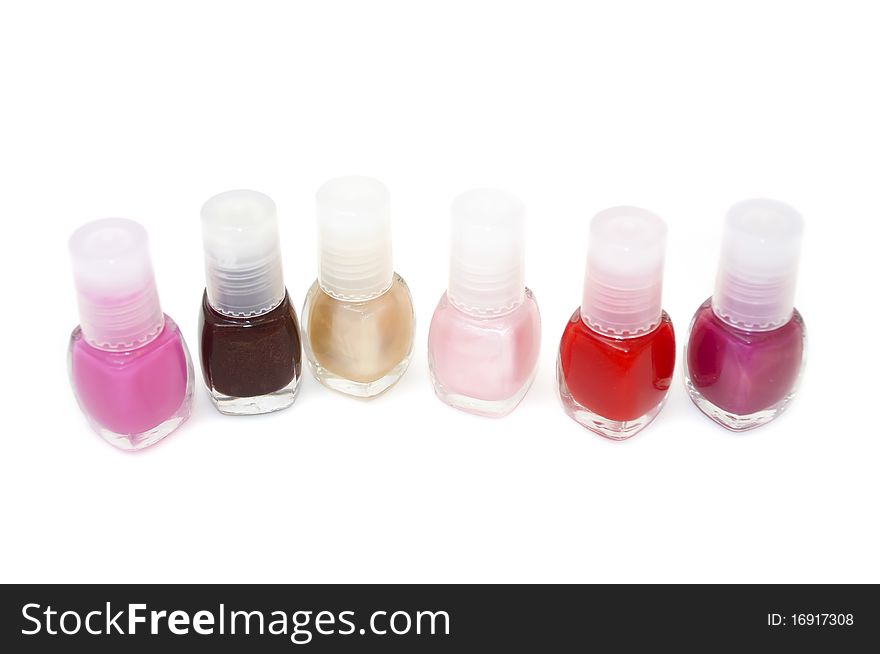 Six bottles of nail polish isolated on a white background