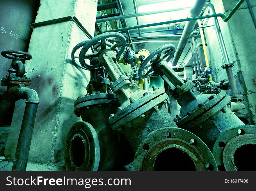 Different size and shaped pipes and valves at a power plant