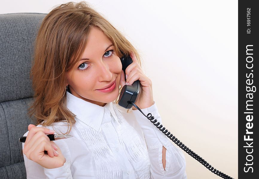 Portrait of young business woman talking on phone