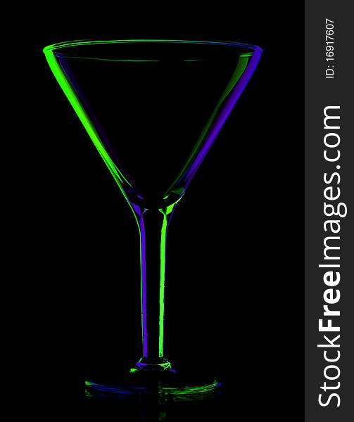 Transparent colored empty martini glass on black