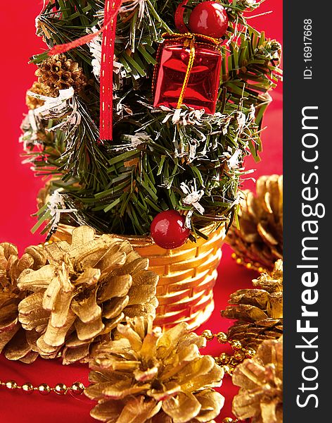 Decorative Christmas tree and cones with a gilt on a red background