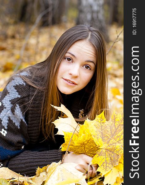 Portrait of amazed girl in autumn park laying on leaves. Portrait of amazed girl in autumn park laying on leaves.