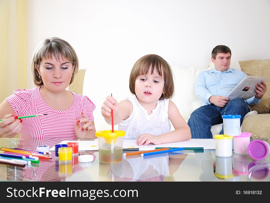 Mother and daughter together paint an album and have fun together.