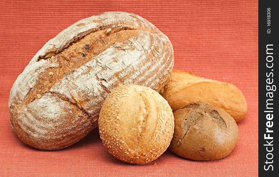 Group of fresh bread on a red background.