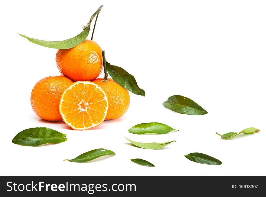 Tangerines with green leaves isolated on white.