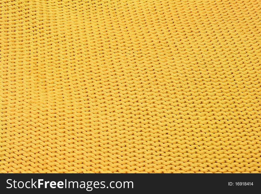 Home knitting yellow texture as background. Home knitting yellow texture as background