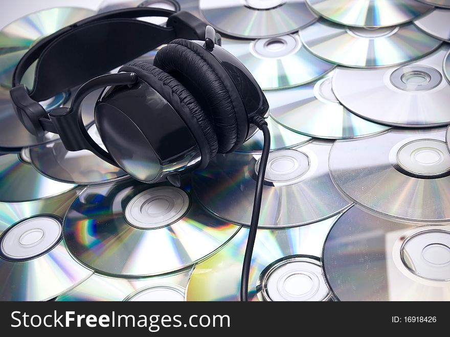 Black headphones on cd background. Black headphones on cd background