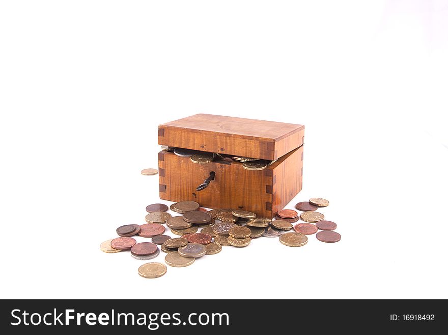 Antique handcrafted wooden money box with small money isolated on a white background