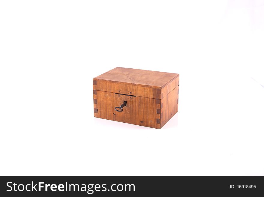 Antique handcrafted closed wooden money box with small money isolated on a white background