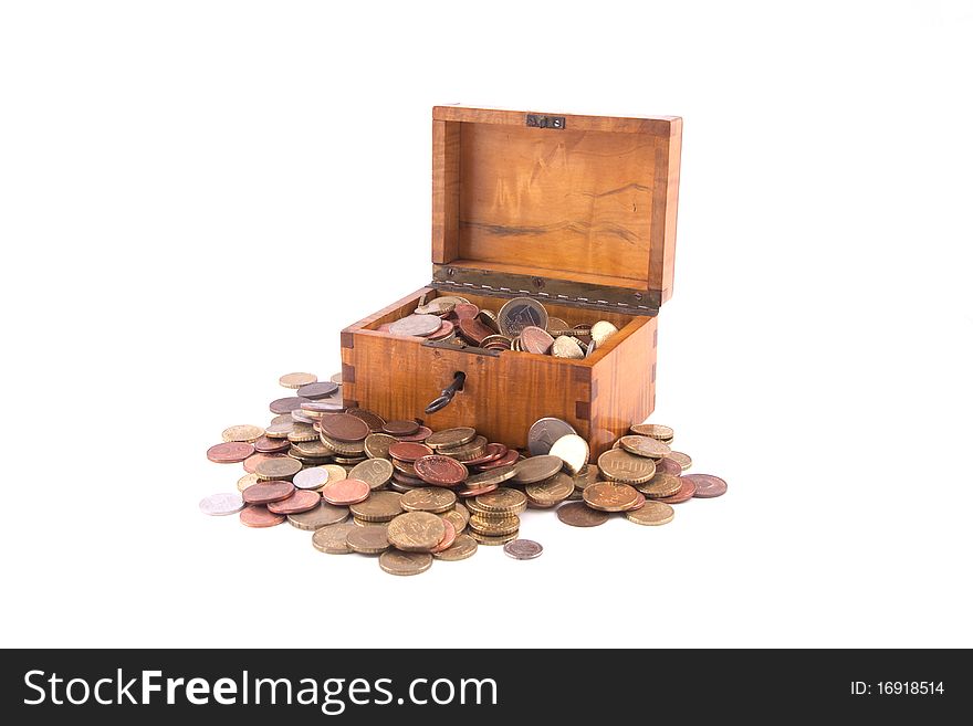 Antique handcrafted open wooden money box with a lot of small money isolated on a white background