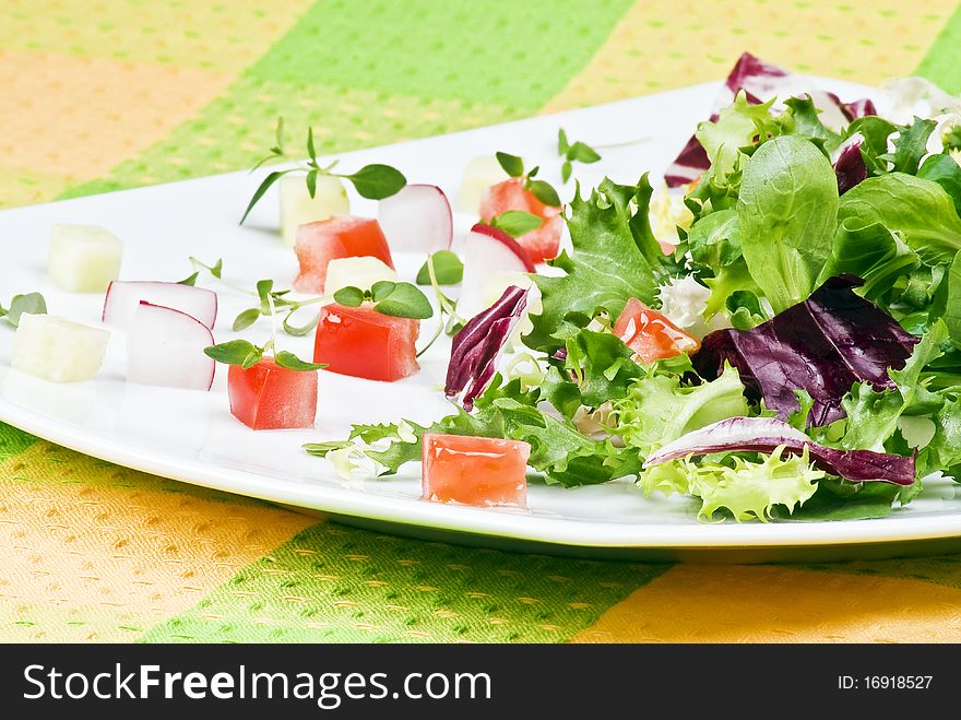 Various salad leaves with tomato, radish and cucumber. Various salad leaves with tomato, radish and cucumber