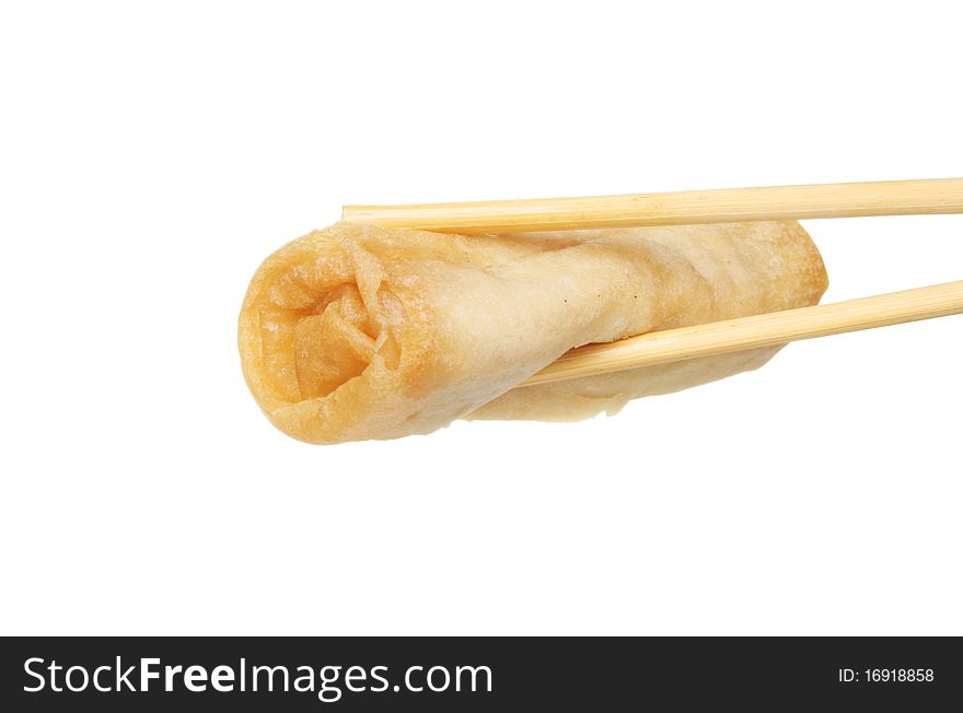 Whole Chinese pancake roll held in a pair of chopsticks against white. Whole Chinese pancake roll held in a pair of chopsticks against white