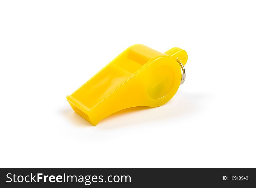 Yellow plastic whistle on a white background. Yellow plastic whistle on a white background.