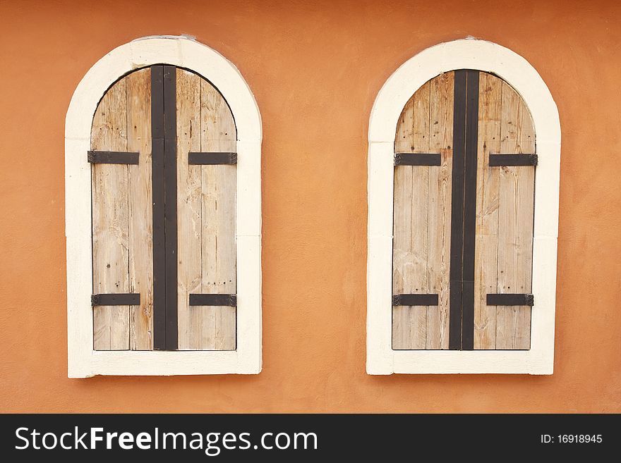 Plain European style windows design elements on orange wall. Plain European style windows design elements on orange wall