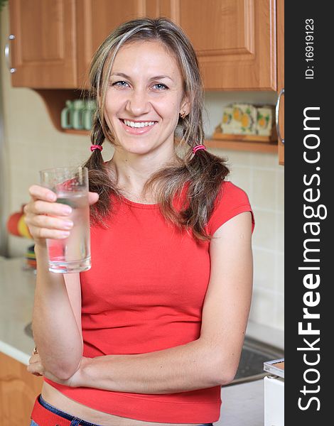 Young woman drinking water at home