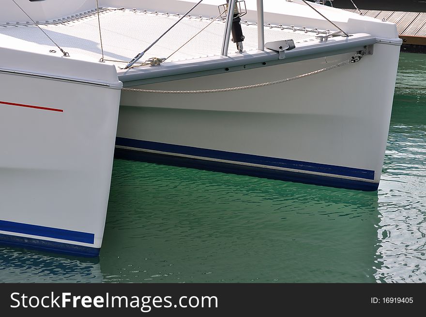 Part of yacht in harbor, shown as marine activity or in maintenance.