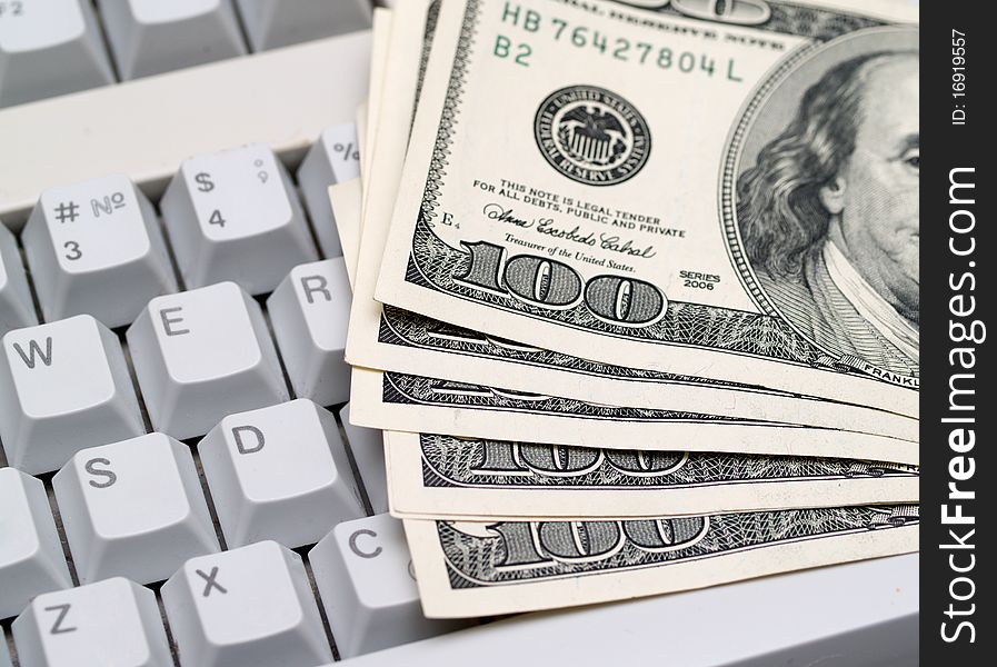 Dollar bills lying on the keyboard