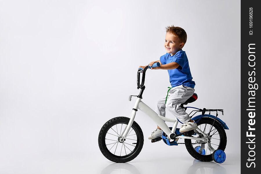 Young boy happily riding on a bicycle on  background