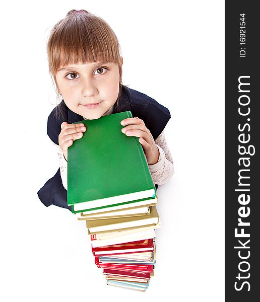 Schoolgirl with books is looking up. Isolated on white background