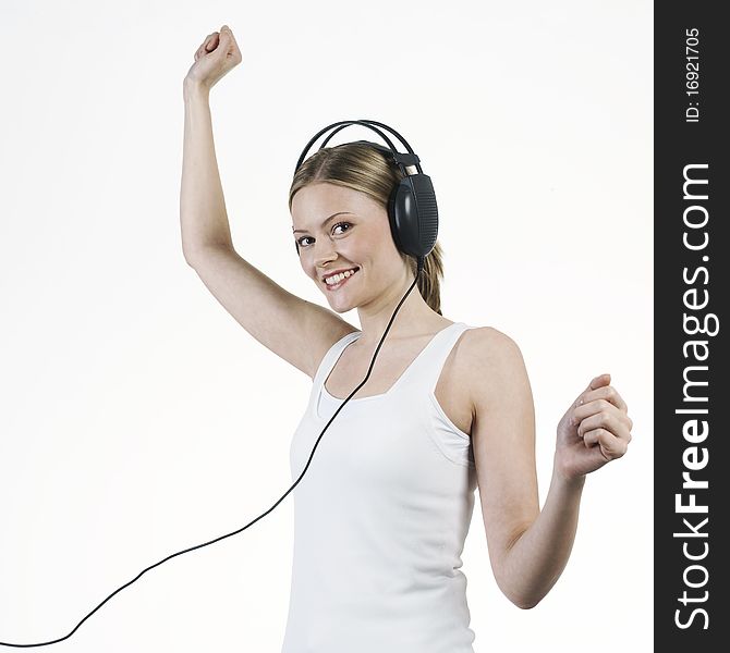 Young woman listening music with headphones and with withe t-shirt