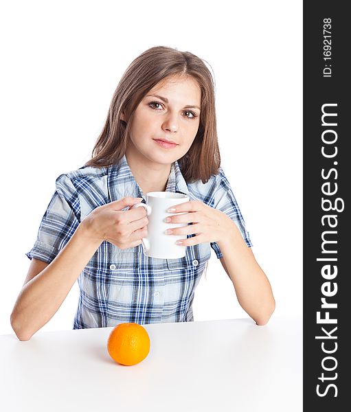 Teen-girl with cup of coffee and two oranges in hand. Isolated on white