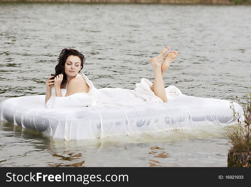 Woman Lying On The Bed In The Sea