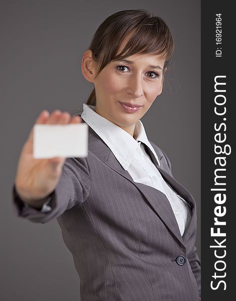 Professional woman showing business card into the camera