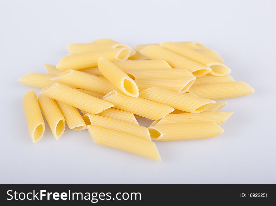 Penne rigate, italian pasta on white