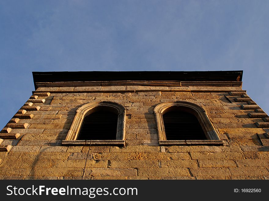 Window of the ancient tower stone wall. Window of the ancient tower stone wall