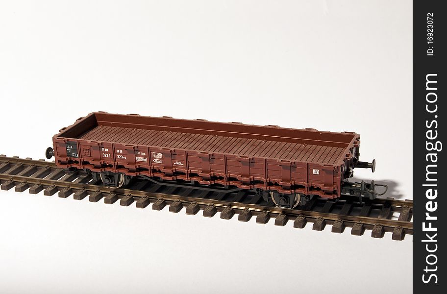 A platform wagon on rail isolated by white background