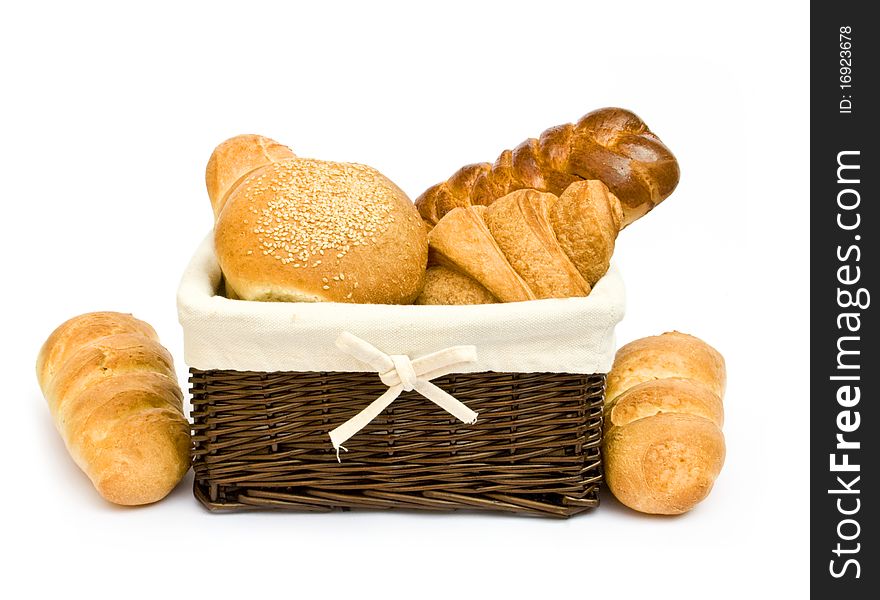 Fresh baked rolls in a basket on white. Fresh baked rolls in a basket on white